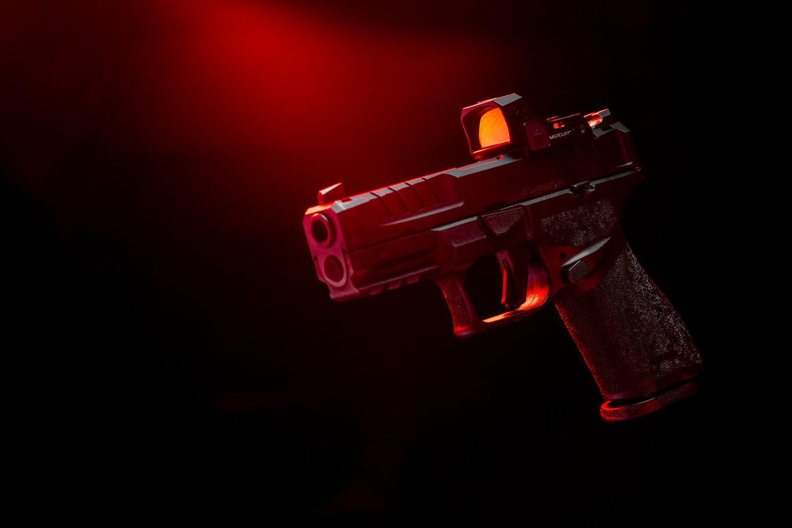 Pistol with Mercury reflex sight in dramatic red studio light